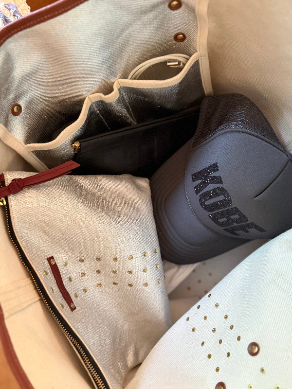 Gray hat with 'Kobe' branding inside a silver bag.